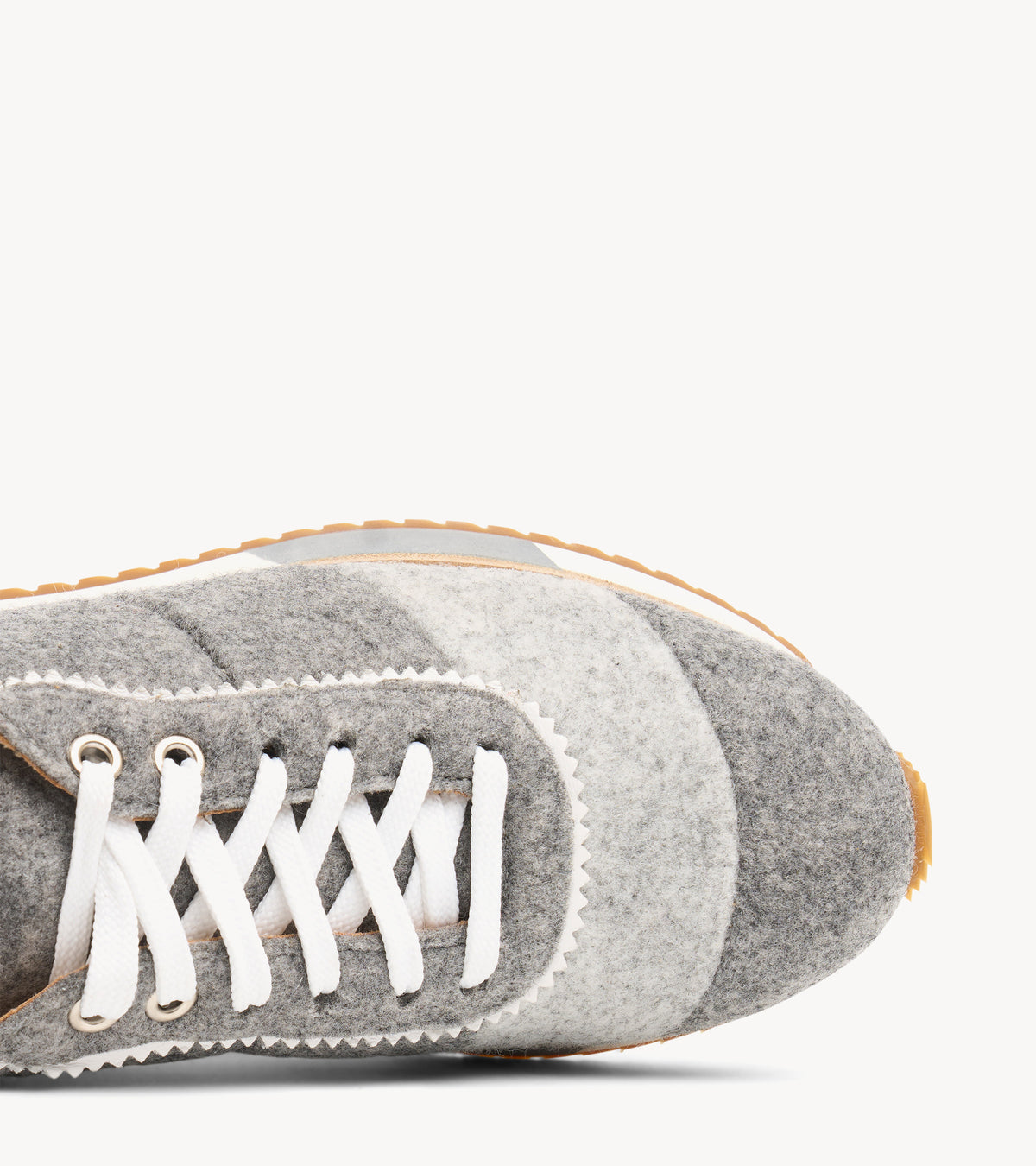 The Quinn Sneaker — close-up of the lacing and stitching on the grey wool sneaker