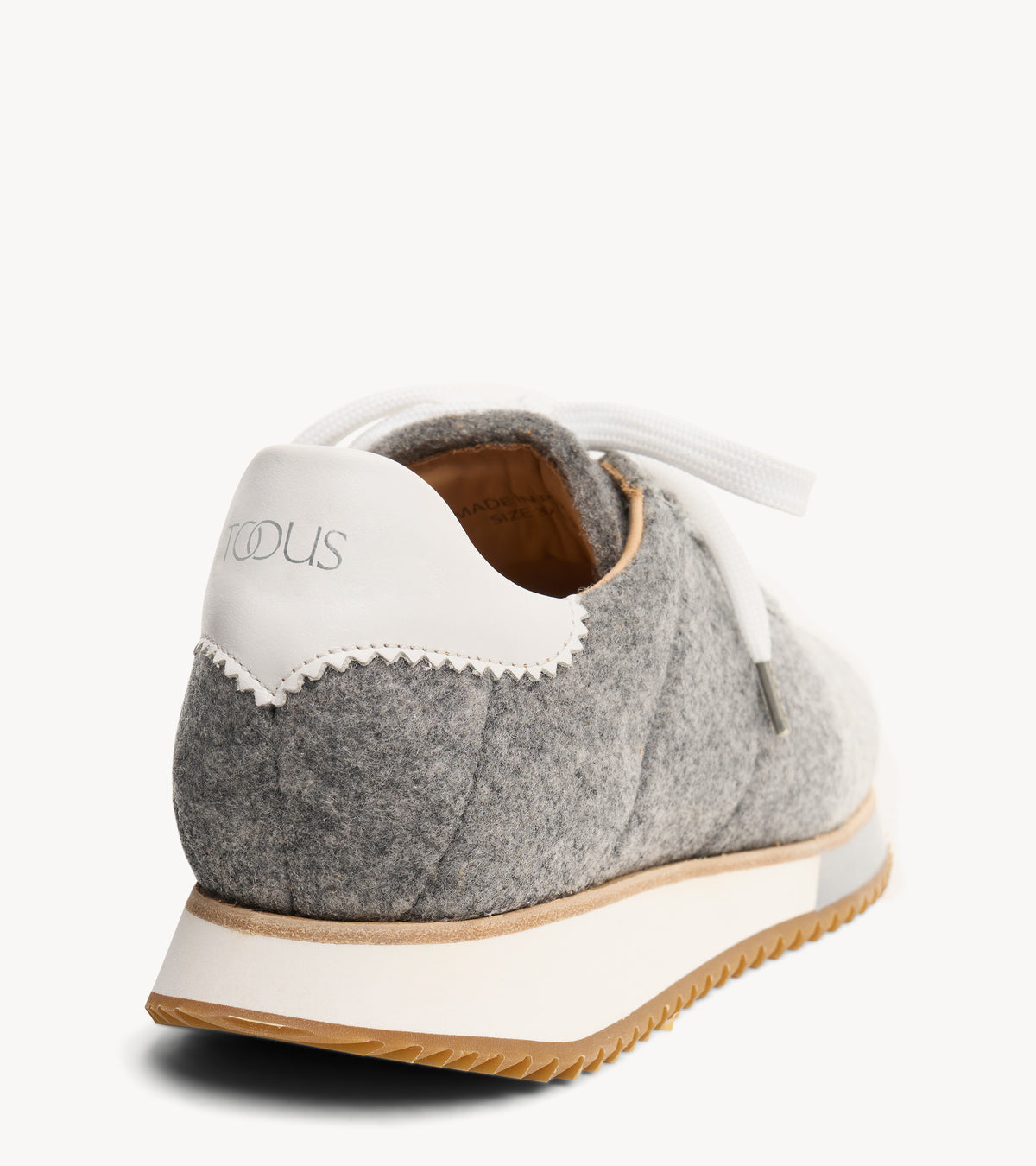 The Quinn Sneaker — back three-quarter view of the grey wool sneaker